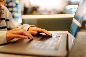 parent and their child with laptop