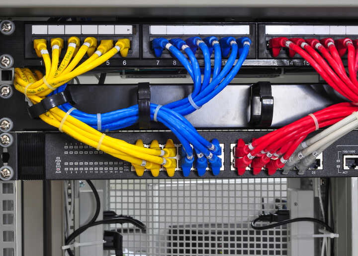 Network cables organised in a server rack.