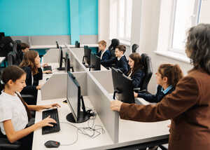 Group of students working on computers in a classroom setting.