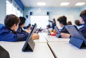 Children in a classroom using tablets Children in a classroom using tablets