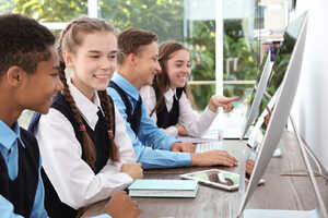 students using desktop computers in school