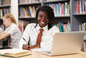 student using a laptop in a classroom