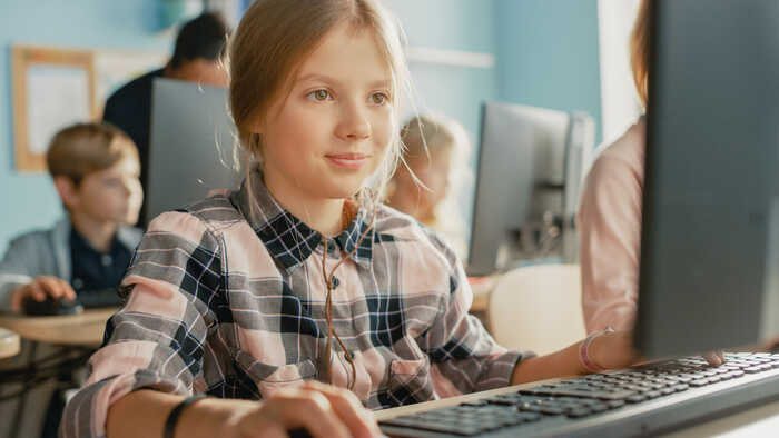 girl using computer in school