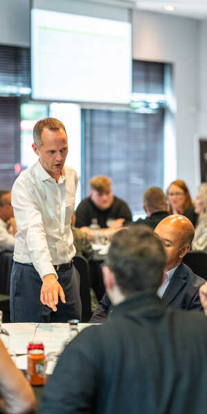 Owen Napier speaking to a group at a conference table.