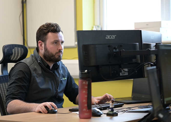 teacher helping students with IT work teacher helping students with IT work