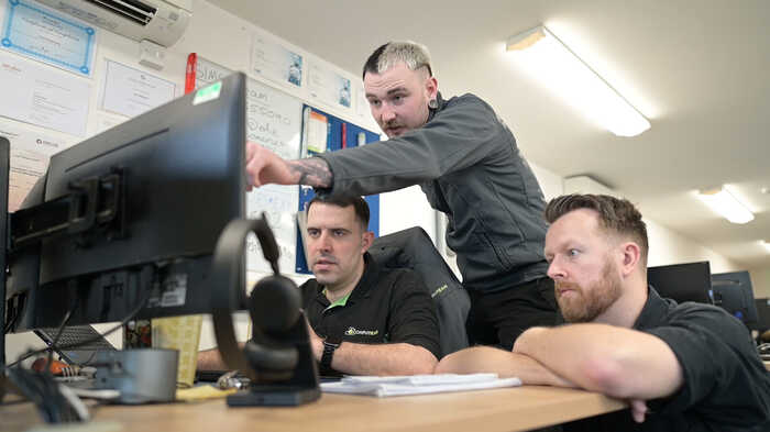 Computeam staff working around a computer