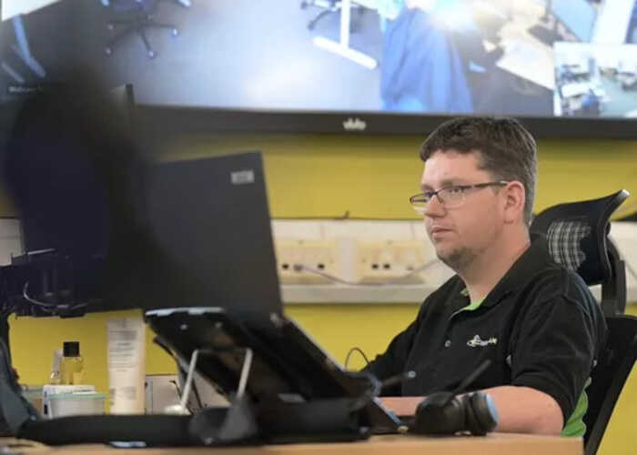 teacher helping students with IT work