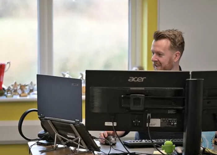teacher helping students with IT work teacher helping students with IT work