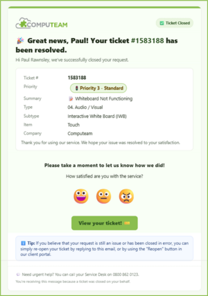 Two students in uniforms focus on a laptop together at a table.