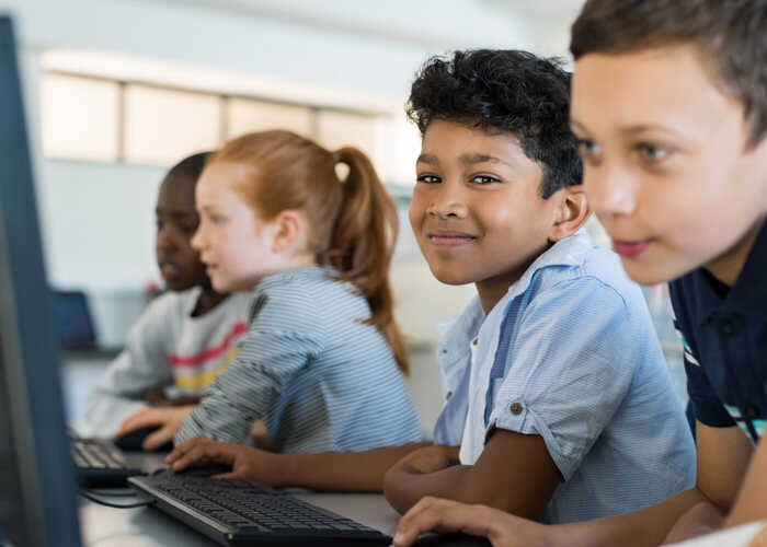 teacher helping students with IT work teacher helping students with IT work