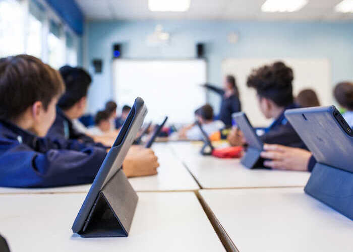 teacher helping students with IT work teacher helping students with IT work