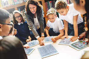 teachers working with students on tablets teachers working with students on tablets