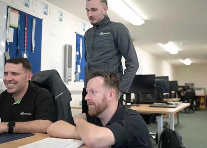 teacher helping students with IT work teacher helping students with IT work