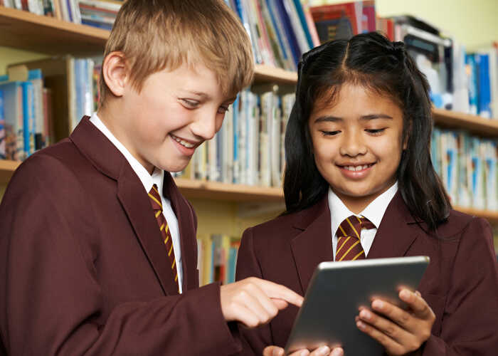teacher helping students with IT work teacher helping students with IT work