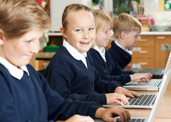 teacher helping students with IT work teacher helping students with IT work